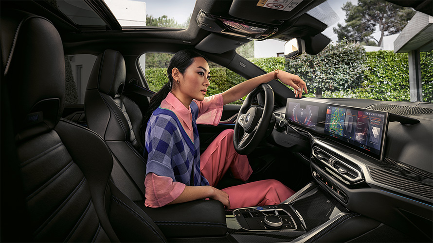 BMW i4 M50 G26 2021 interior with woman in driver's seat